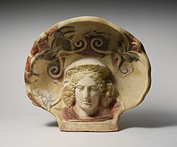 Terracotta antefix (roof tile) with head of a maenad MET DP251364.jpg