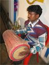 A Santal drummer playing Tumda.jpg