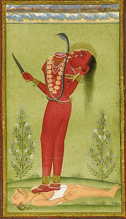 A decapitated, nude, red-complexioned woman stands on a man lying on the ground. She holds in her left hand her severed hand that drinks the blood jet sprouting from her neck. She holds a knife in her other hand. She wears a serpent across her torso and various gold and pearl ornaments.