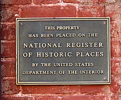 Sign on a brick wall describing a national historic landmark.