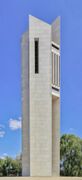 A large white brick bell tower in Canberra, Australia.