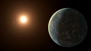 Image showing a red star and three planets. GJ357d is green and covered with life.