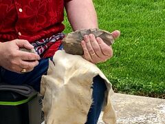 Nicholas Toth using a hammerstone to flake stone, creating an Acheulean hand axe.