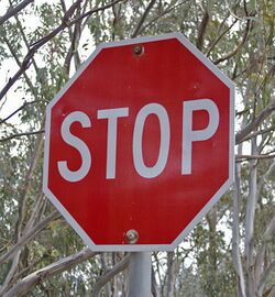 A red stop sign that alerts drivers to stop