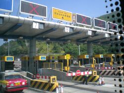 HK Toll road gates n Autotoll sign in yellow color.JPG