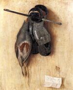 A dead bird and two leather gloves haanging on a wall
