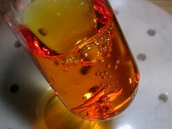Orange liquid containing bubbles