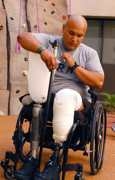 File:US Navy 071012-N-8327R-048 Spc. Saul Martinez, who sustained injury during combat, attaches his prosthetic leg after climbing the new 30-foot wall in the Comprehensive Combat and Complex Casualty Care (C5) facility.jpg