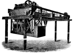 Steam-powered overhead crane from ca. 1890. Three separate, two-cylinder engines provided transverse, longitudinal, and hoisting motion; a feature of the design was the ability to raise or lower the load while in transit.